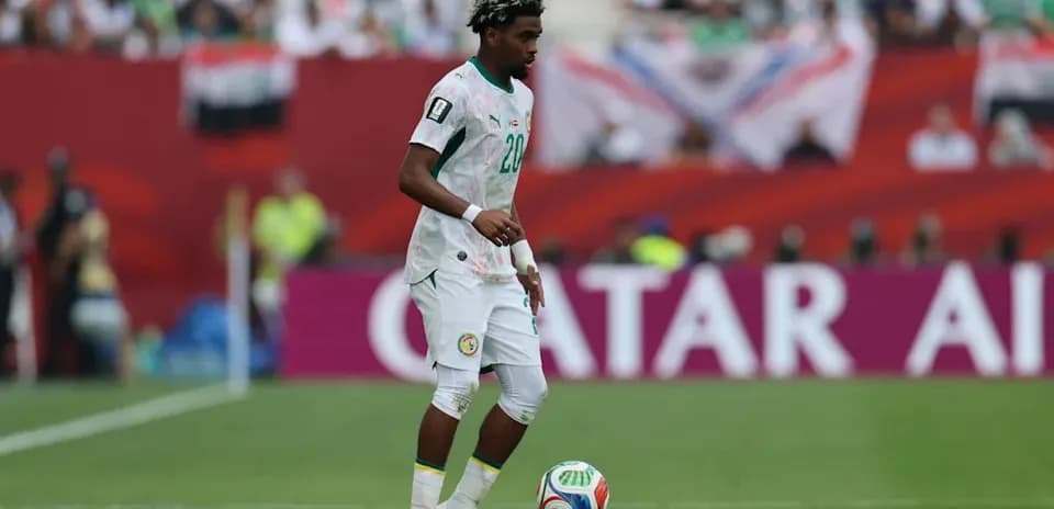 Player from Senegal dribbling ball on field