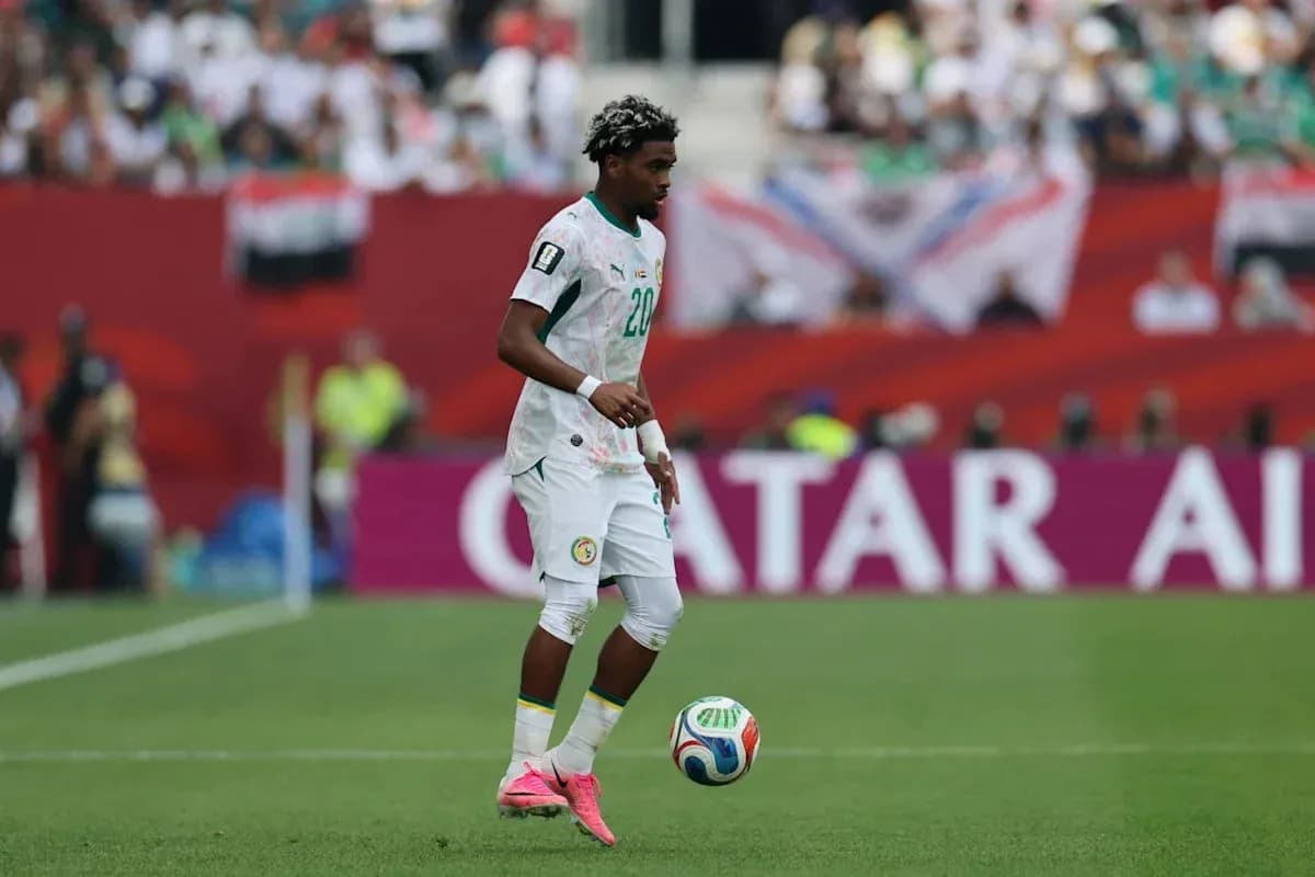 Player from Senegal dribbling ball on field