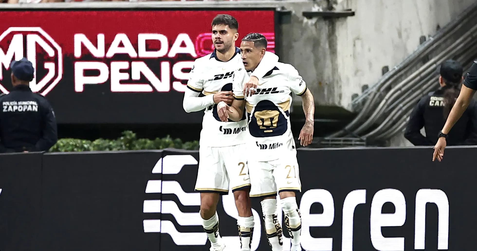Pumas players celebrating a goal during match