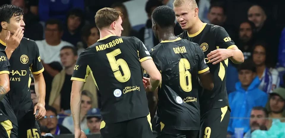 Players celebrating during a match in black jerseys