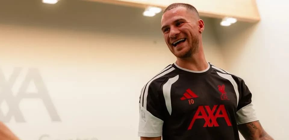 Player wearing Liverpool training kit in training center