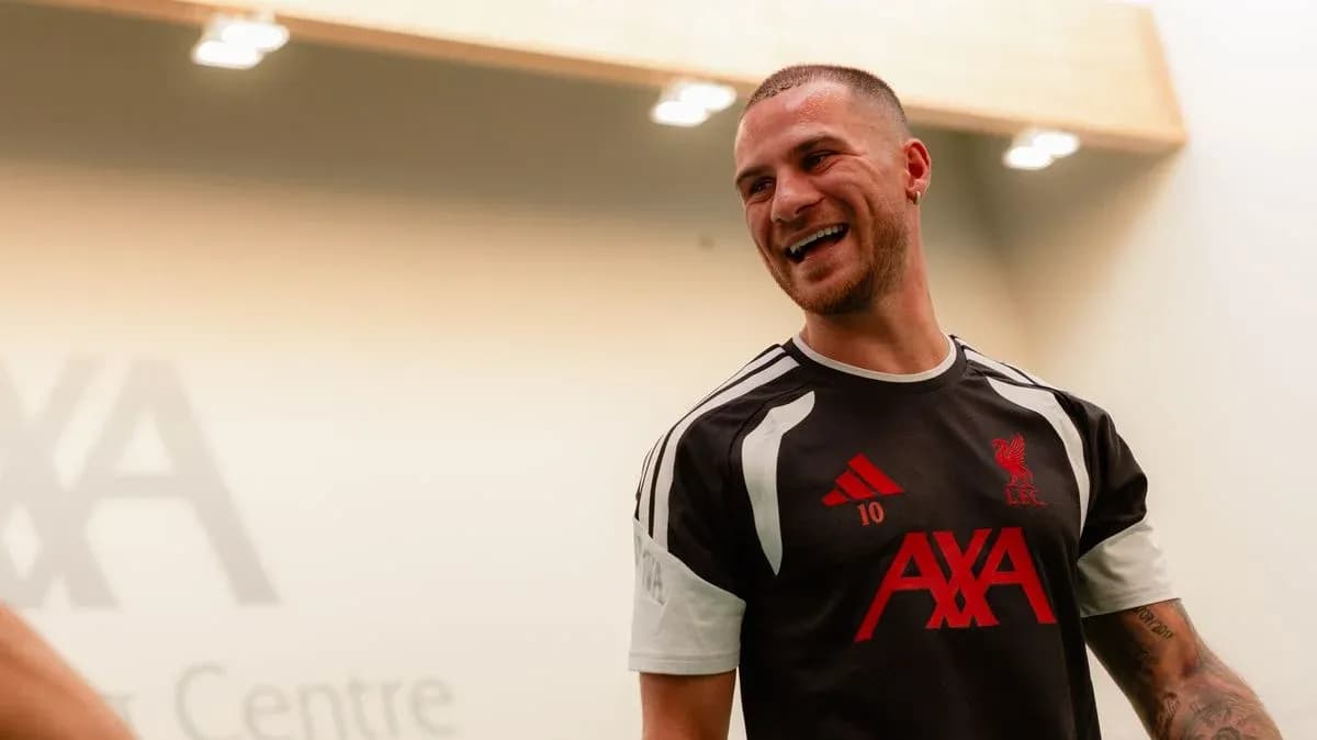 Player wearing Liverpool training kit in training center
