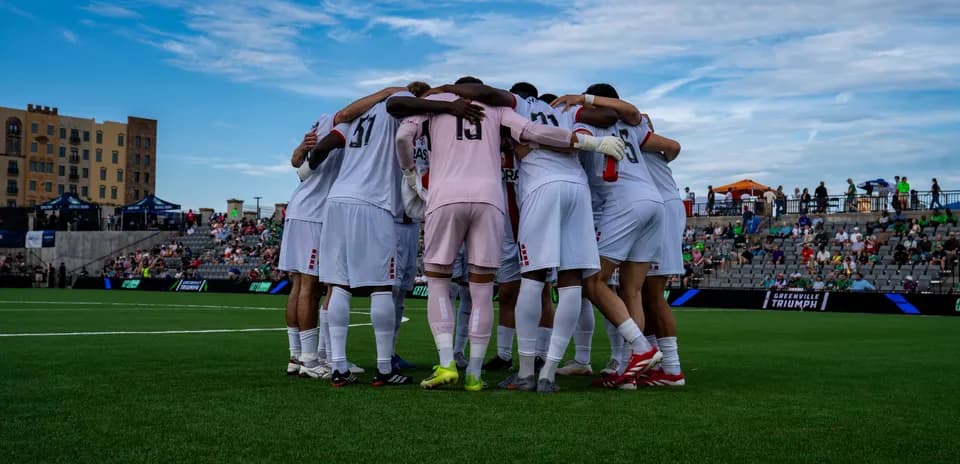 Players huddling before the match