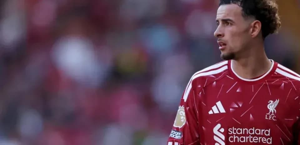 Player wearing Liverpool jersey on the pitch