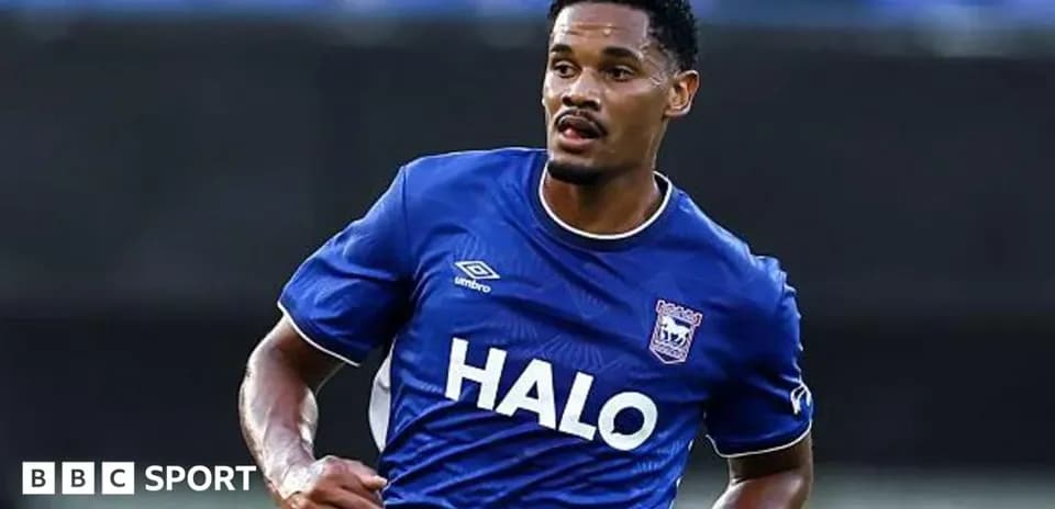 Player in blue kit running on the field