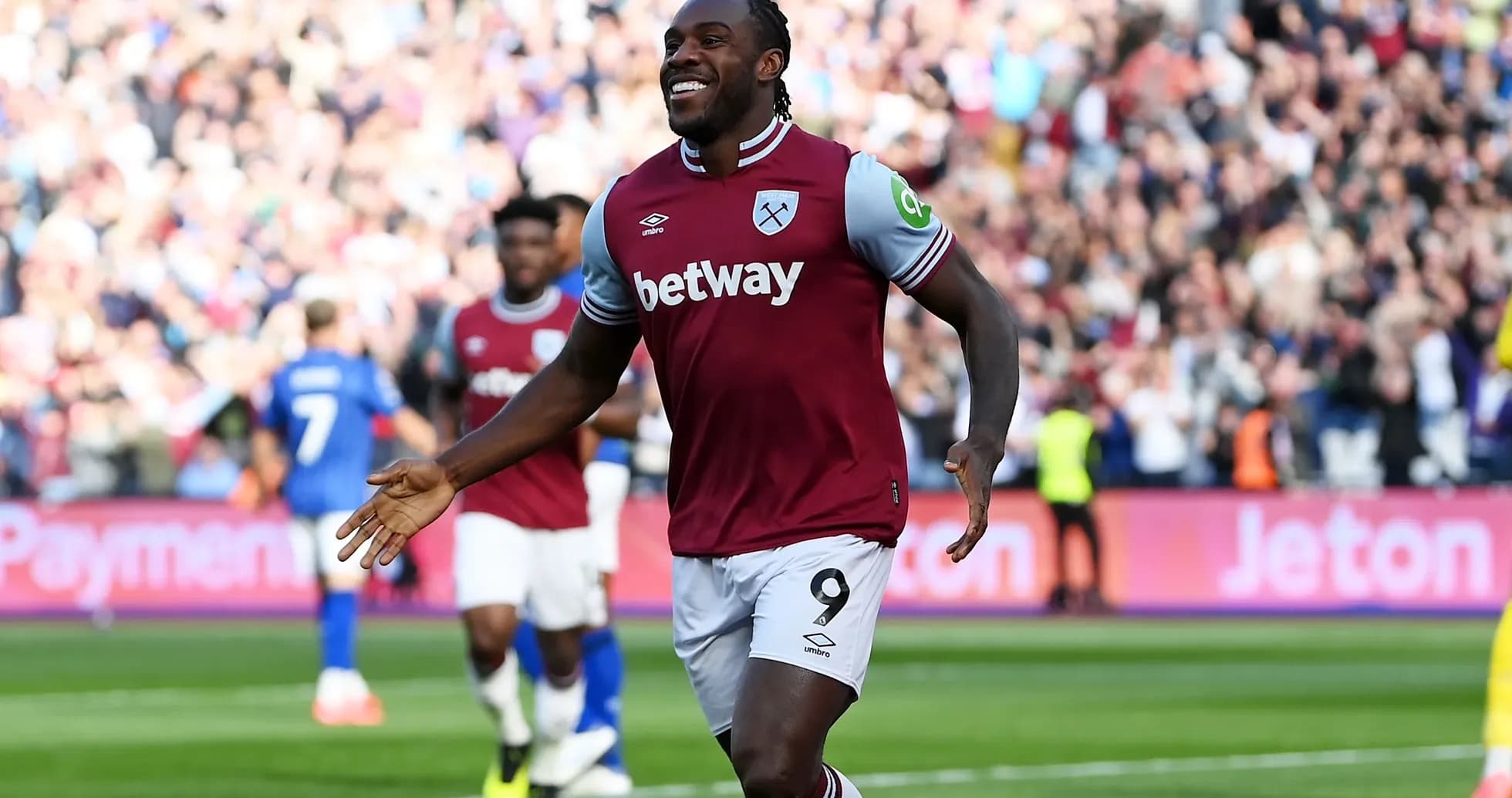Player celebrating goal with fans in stadium