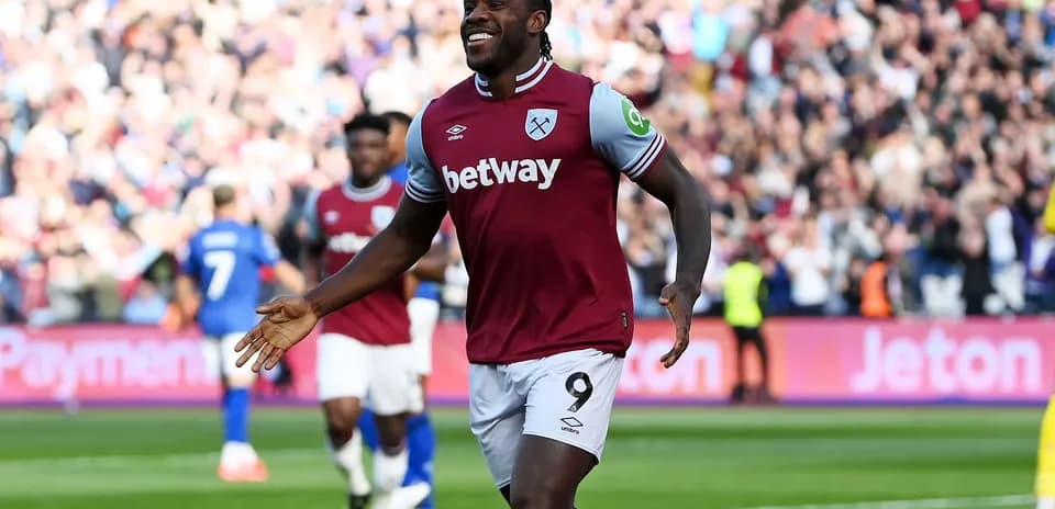 Player celebrating goal with fans in stadium