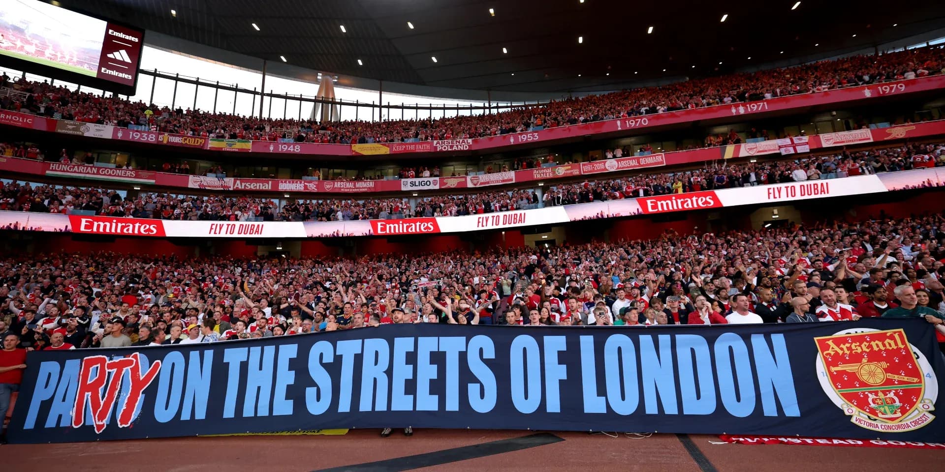 Arsenal fans holding banner at Emirates Stadium
