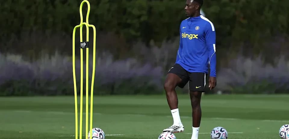 Player practicing near training cones and soccer balls