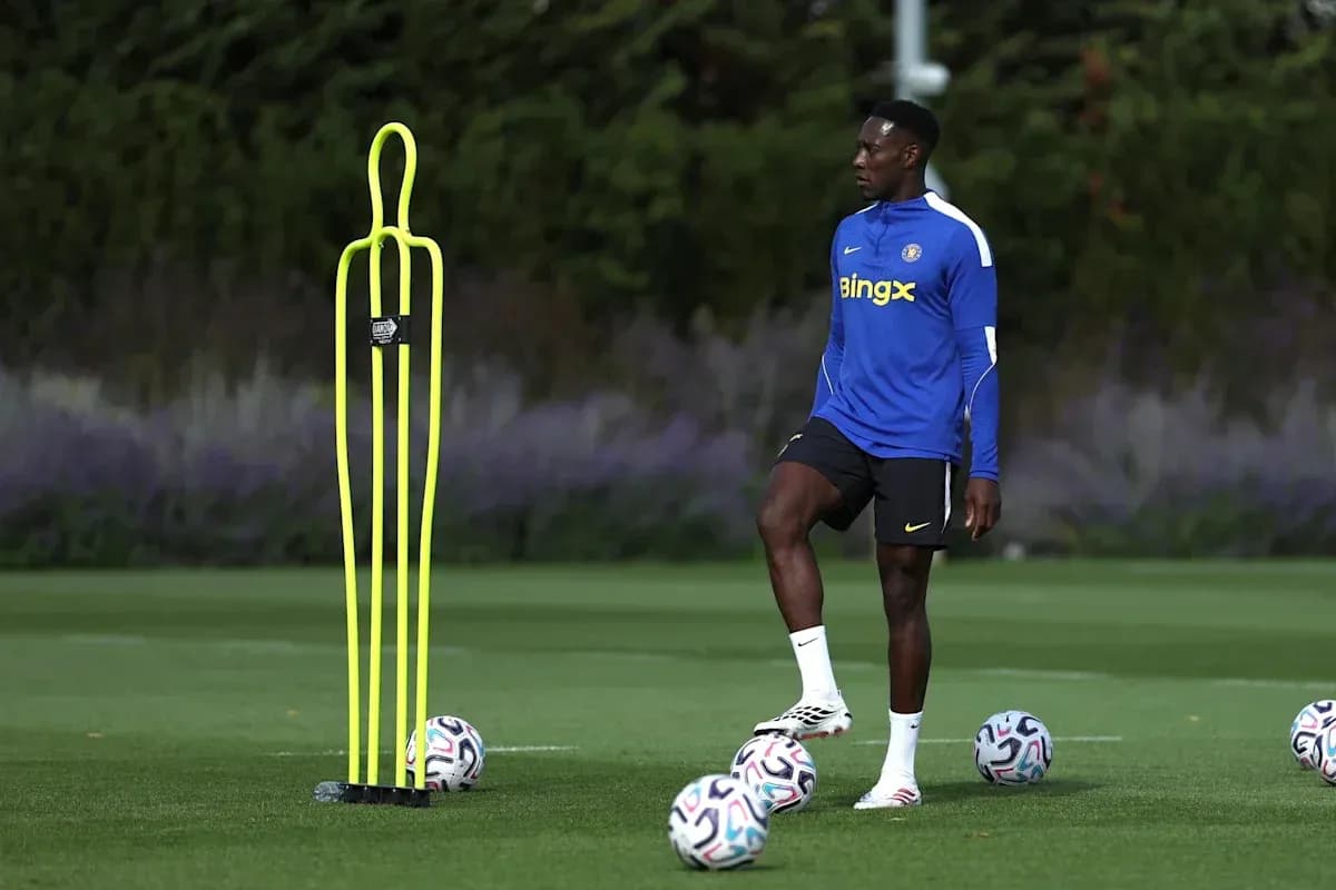 Player practicing near training cones and soccer balls