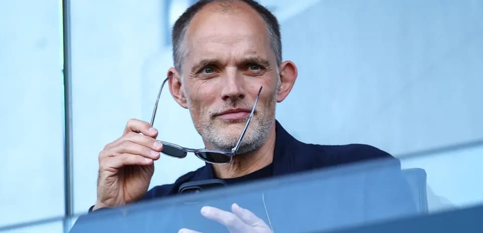 Man holding glasses while looking thoughtfully