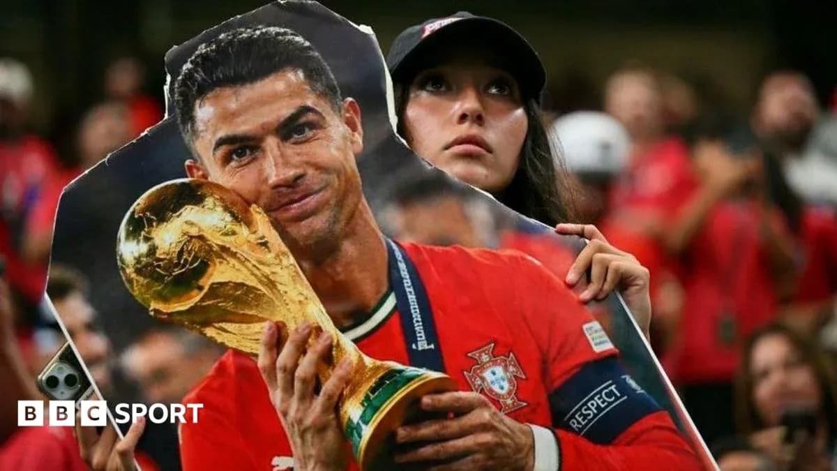Fan holding cutout of player with trophy