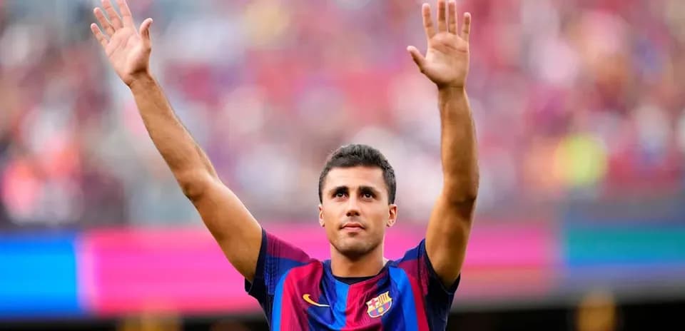 Player celebrating with raised hands at Camp Nou
