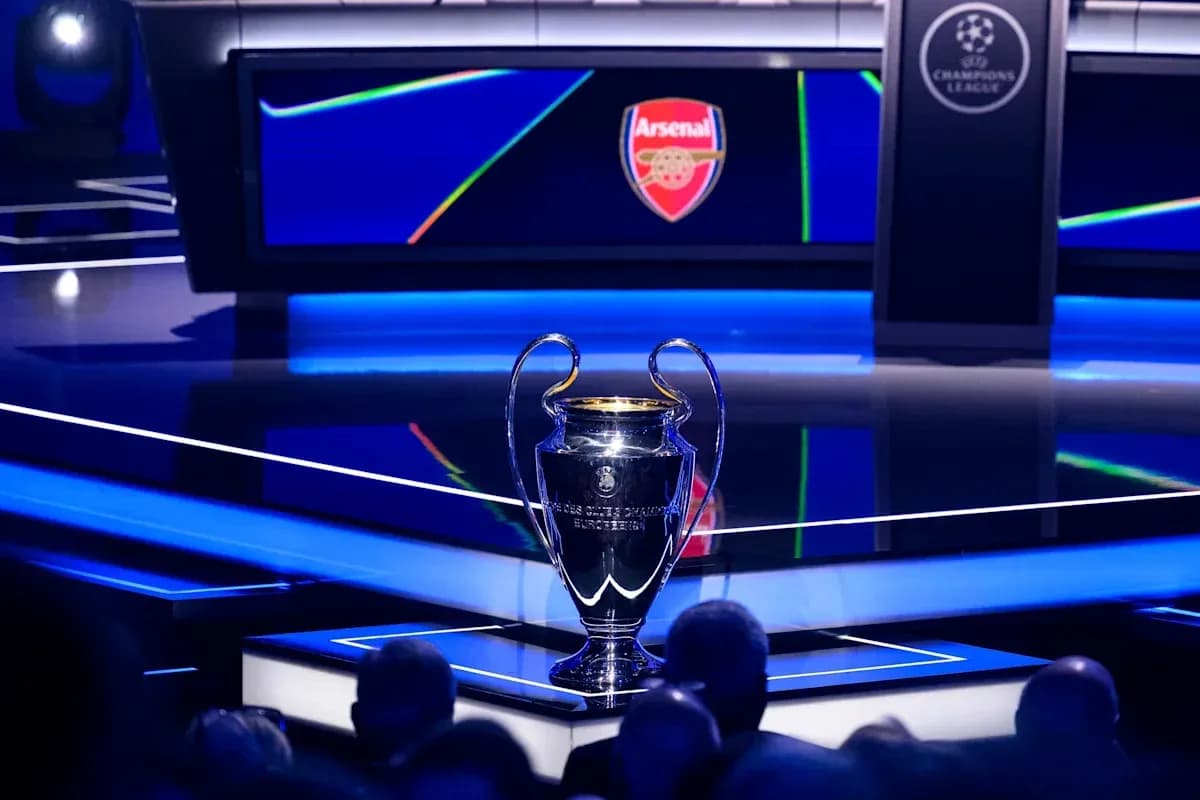 Champions League trophy displayed with Arsenal logo