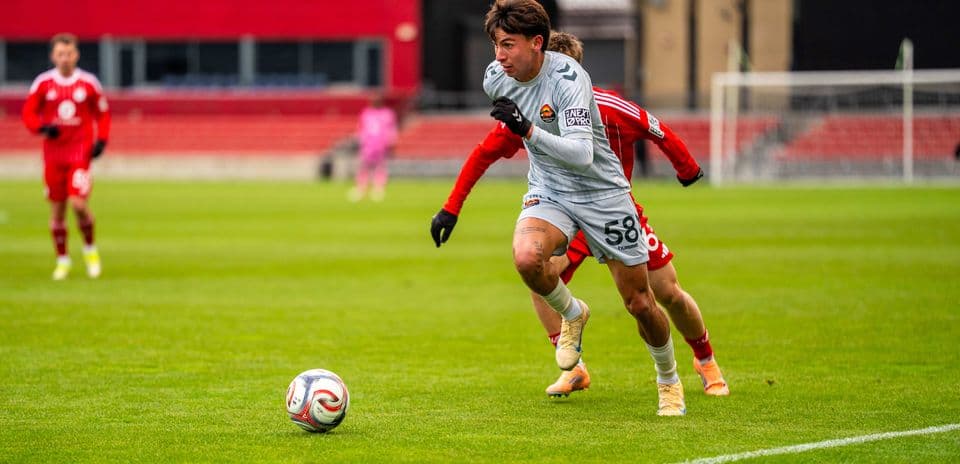 Player sprinting with ball during MLS Next Pro match