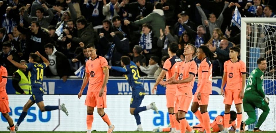 Players in pink jerseys react to a goal celebration