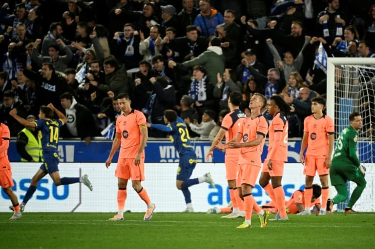 Players in pink jerseys react to a goal celebration