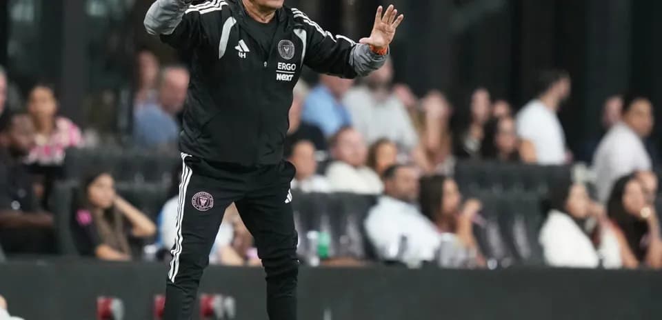 Coach directing players from the sideline during match