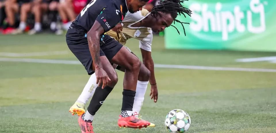 Players contesting the ball during USL Championship match