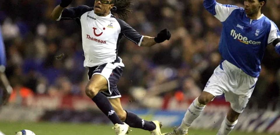 Player evading a tackle during a football match