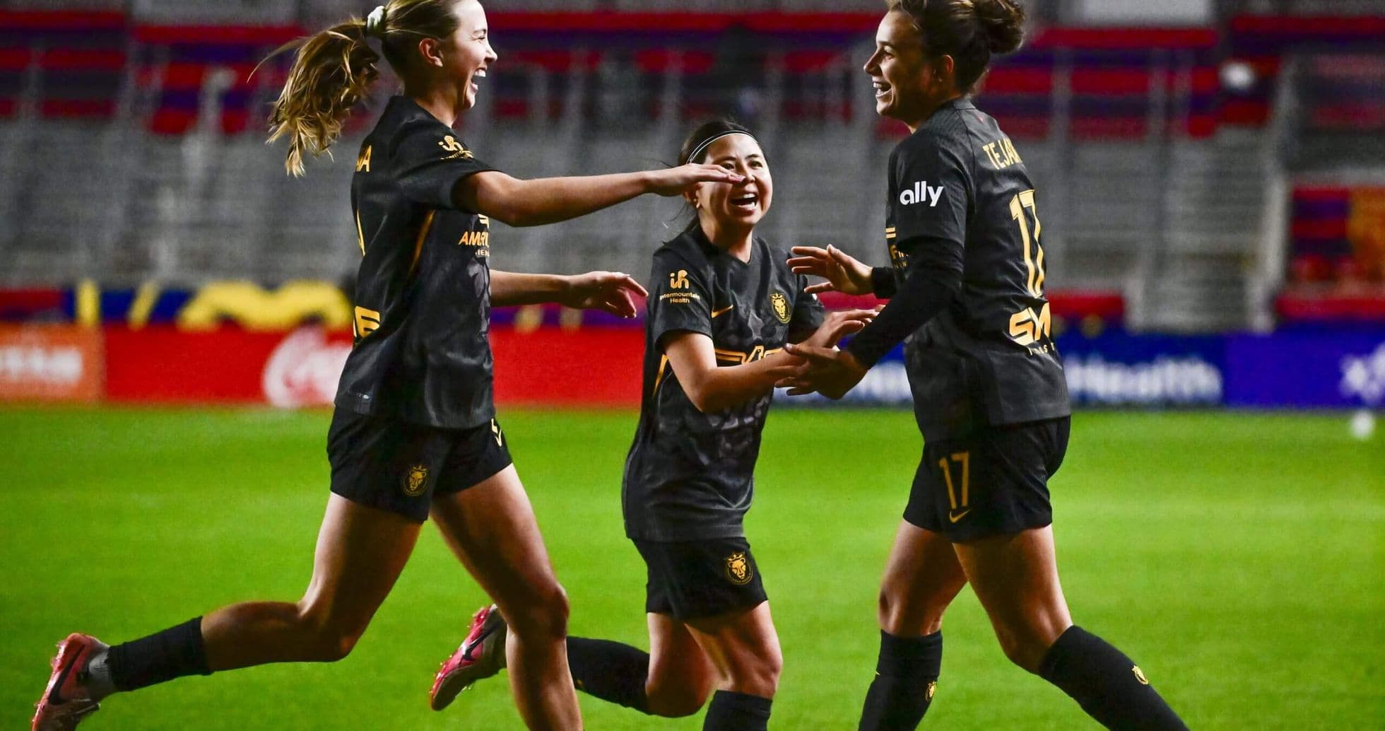 Players celebrating a goal during NWSL match