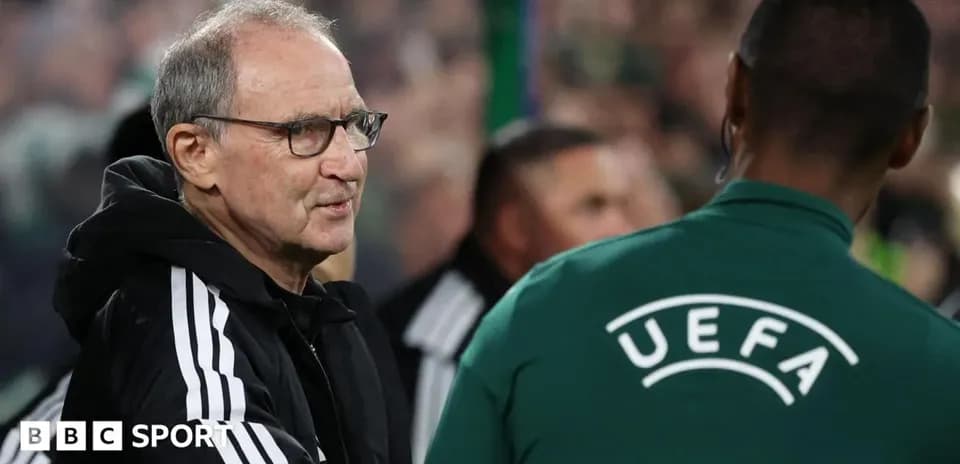 Coach greeting UEFA official during match