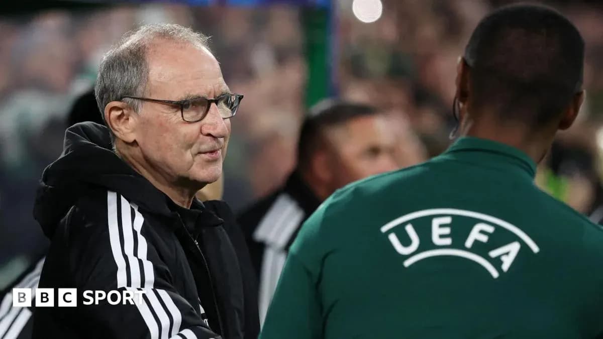 Coach greeting UEFA official during match