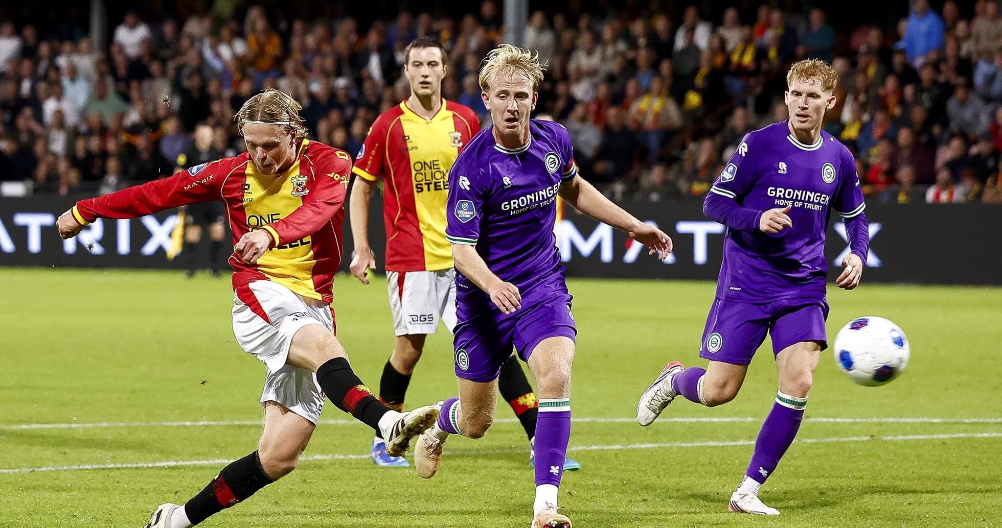 Player kicking ball during competitive football match