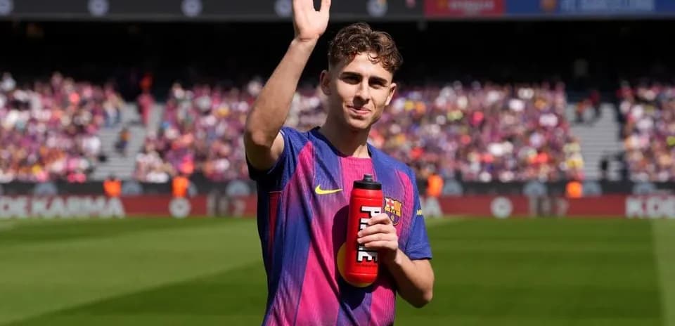 Player waving with water bottle at stadium