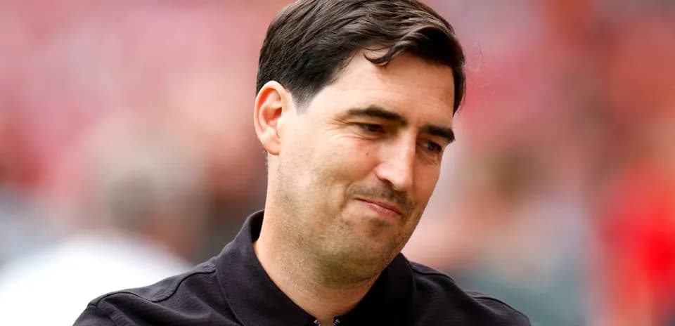 Man in black shirt smiling on the field