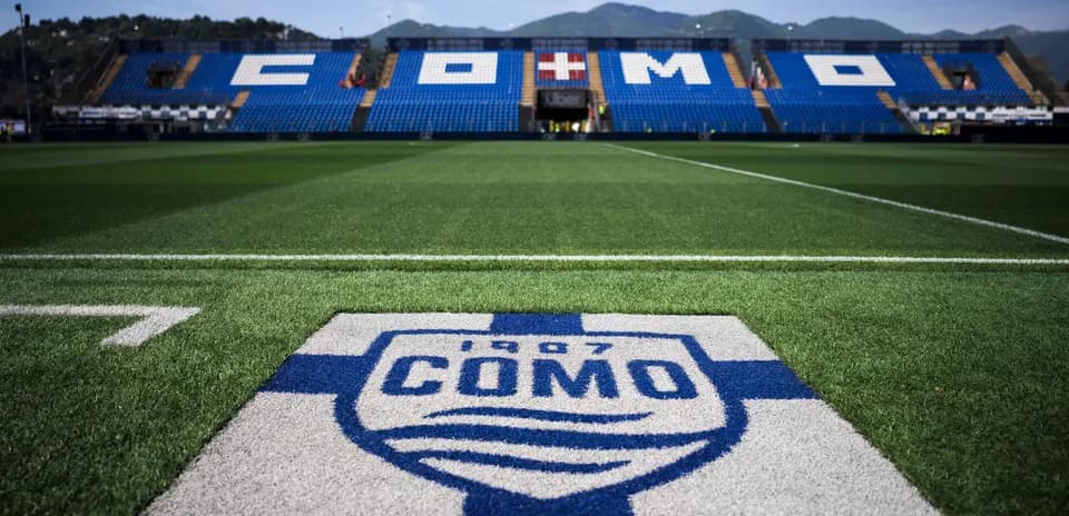Como stadium field with team logo in foreground