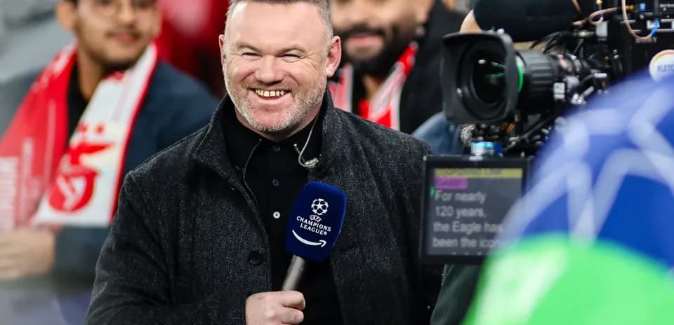 Presenter smiling with microphone at UEFA Champions League