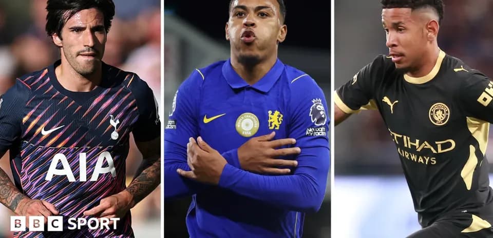 Three football players in team kits during match