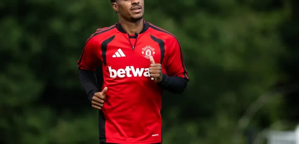 Player jogging during training session in red kit
