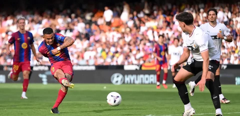 Barcelona player taking a shot on goal during match