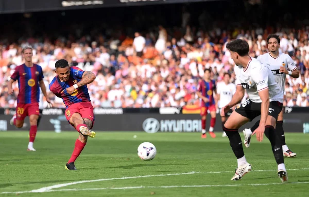 Barcelona player taking a shot on goal during match