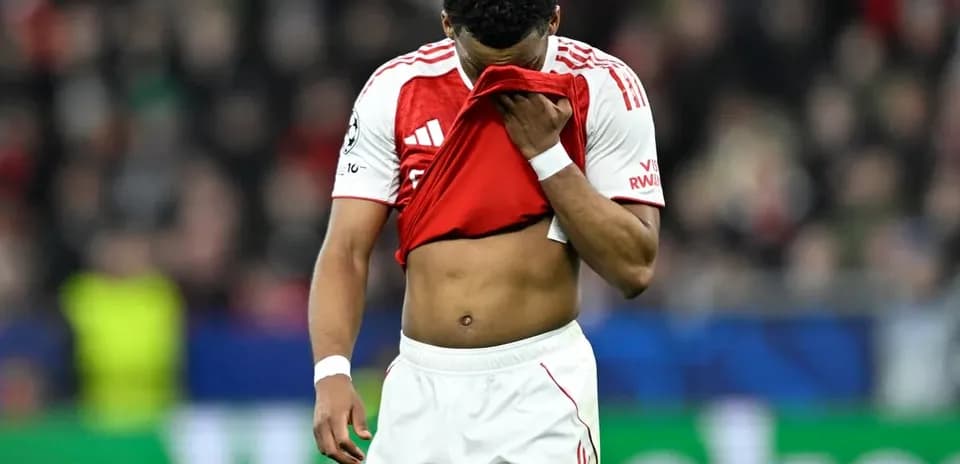 Player holding shirt to face on the field