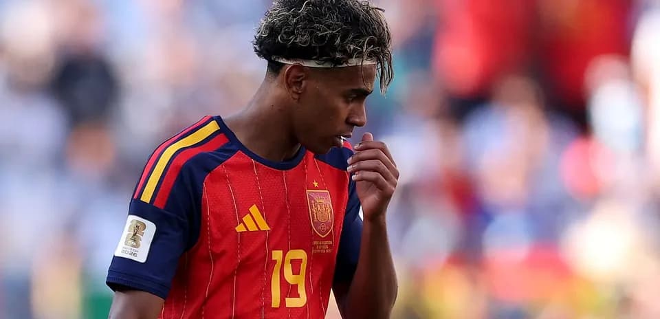 Player wearing Spain jersey during match, looking down