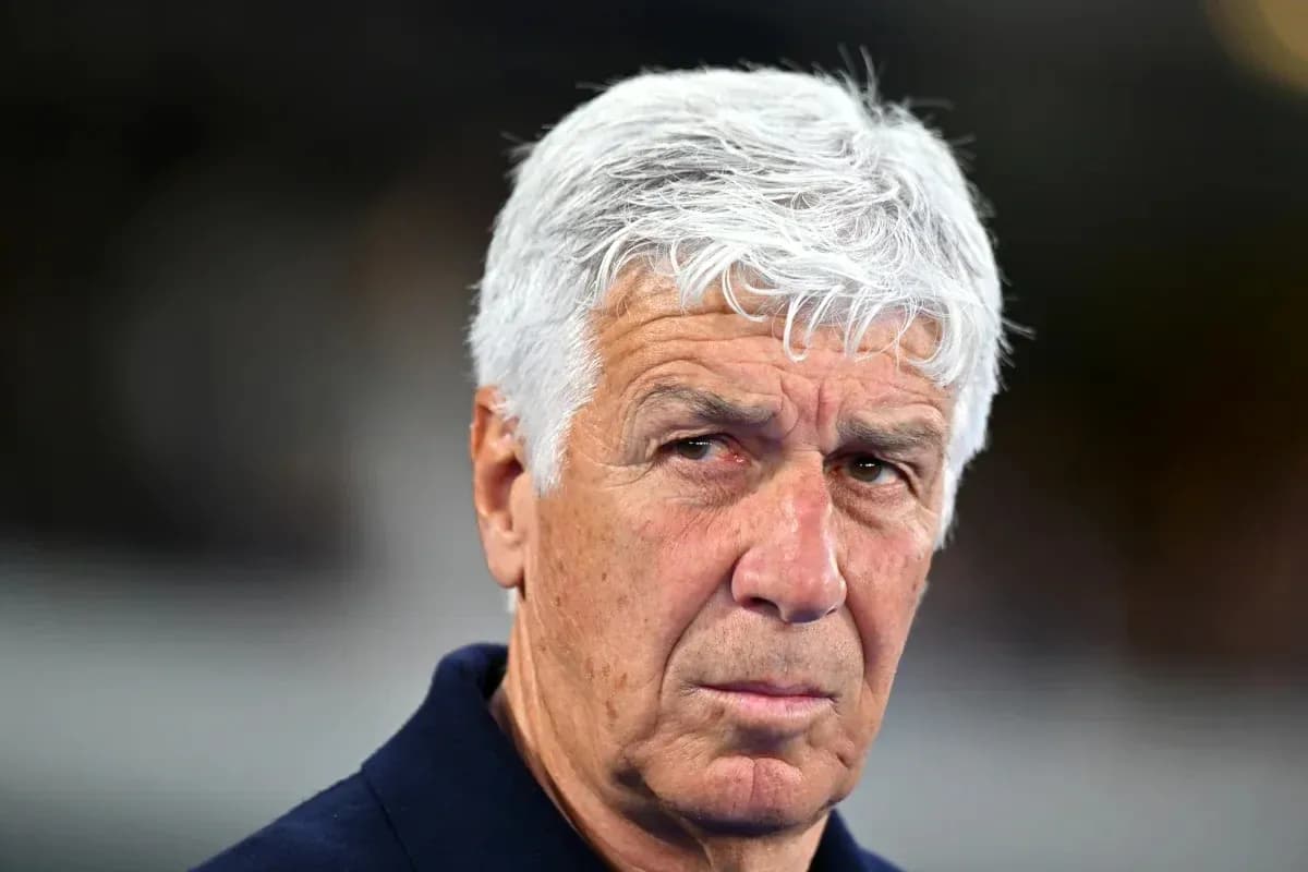 Coach with gray hair looking intently at camera
