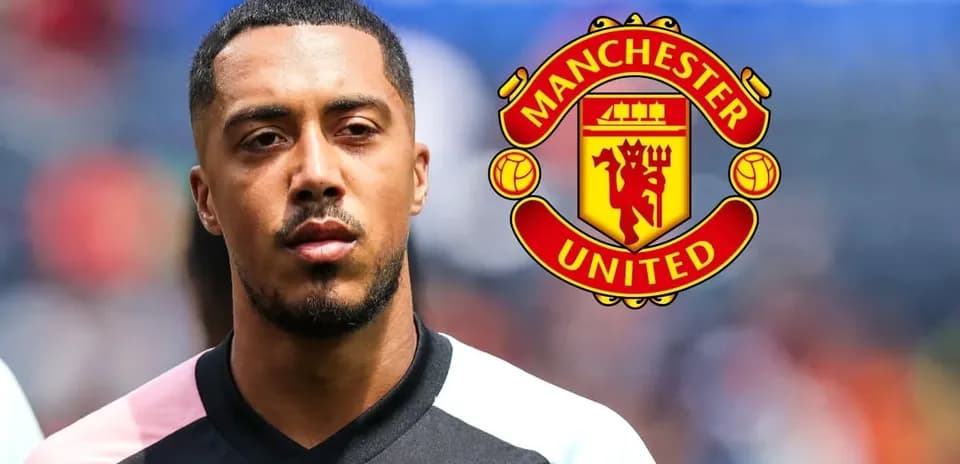 Player standing with Manchester United logo in background