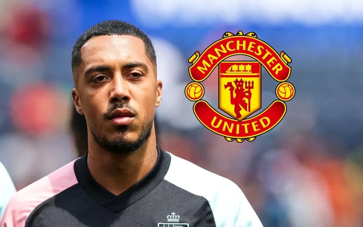 Player standing with Manchester United logo in background