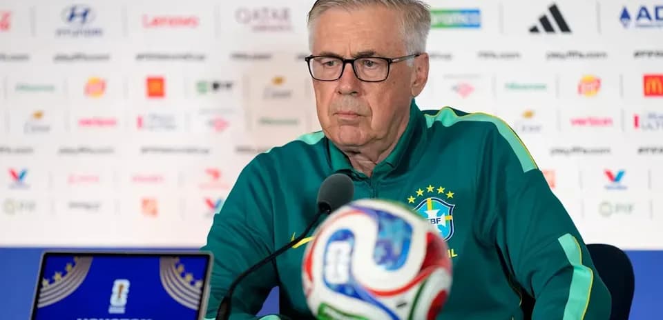 Manager at press conference with soccer ball in front