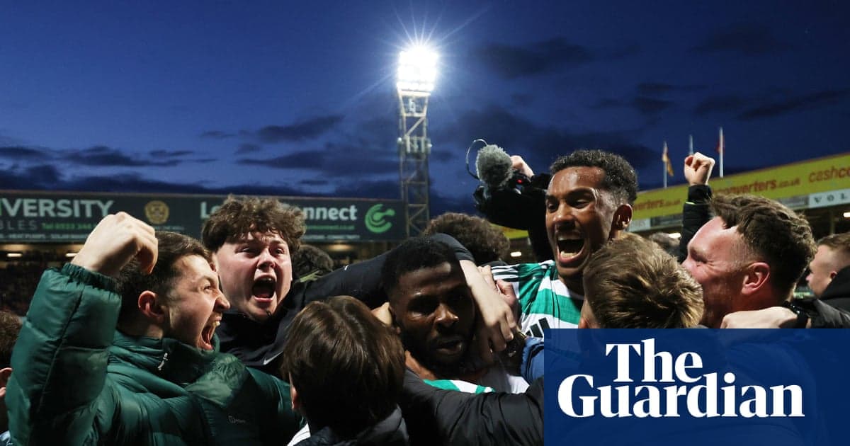 Fans celebrating together in stadium during match