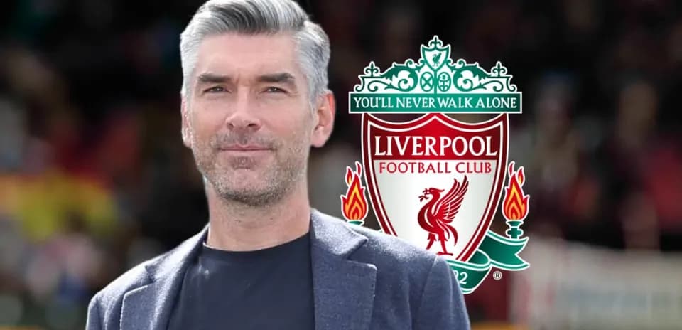 Man posing with Liverpool FC logo in background