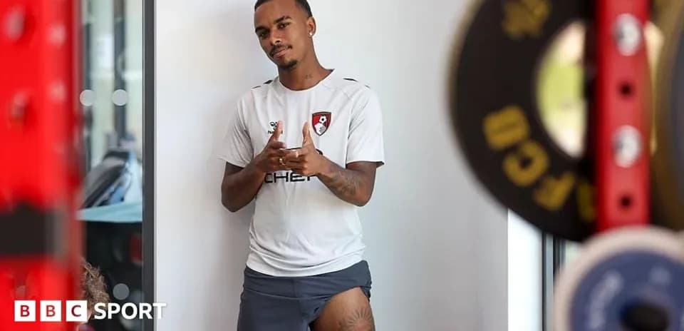 Player posing in training gear near gym equipment