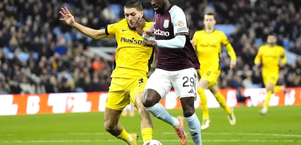 Player dribbling the ball under defensive pressure