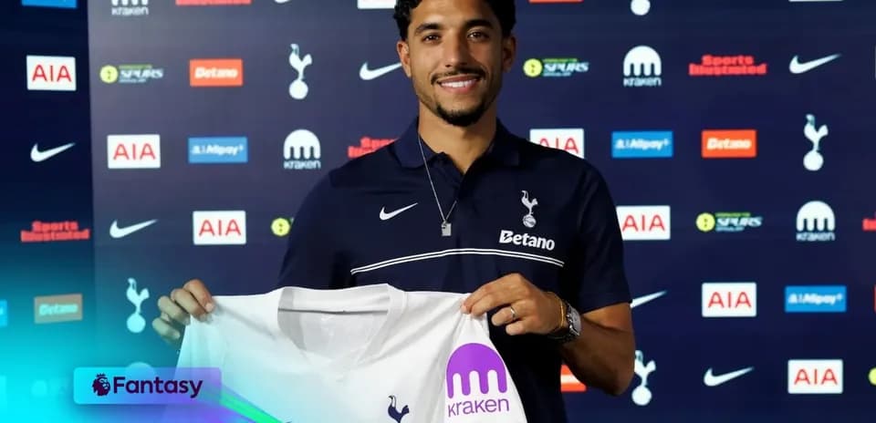 Player holding Tottenham Hotspur jersey at signing event