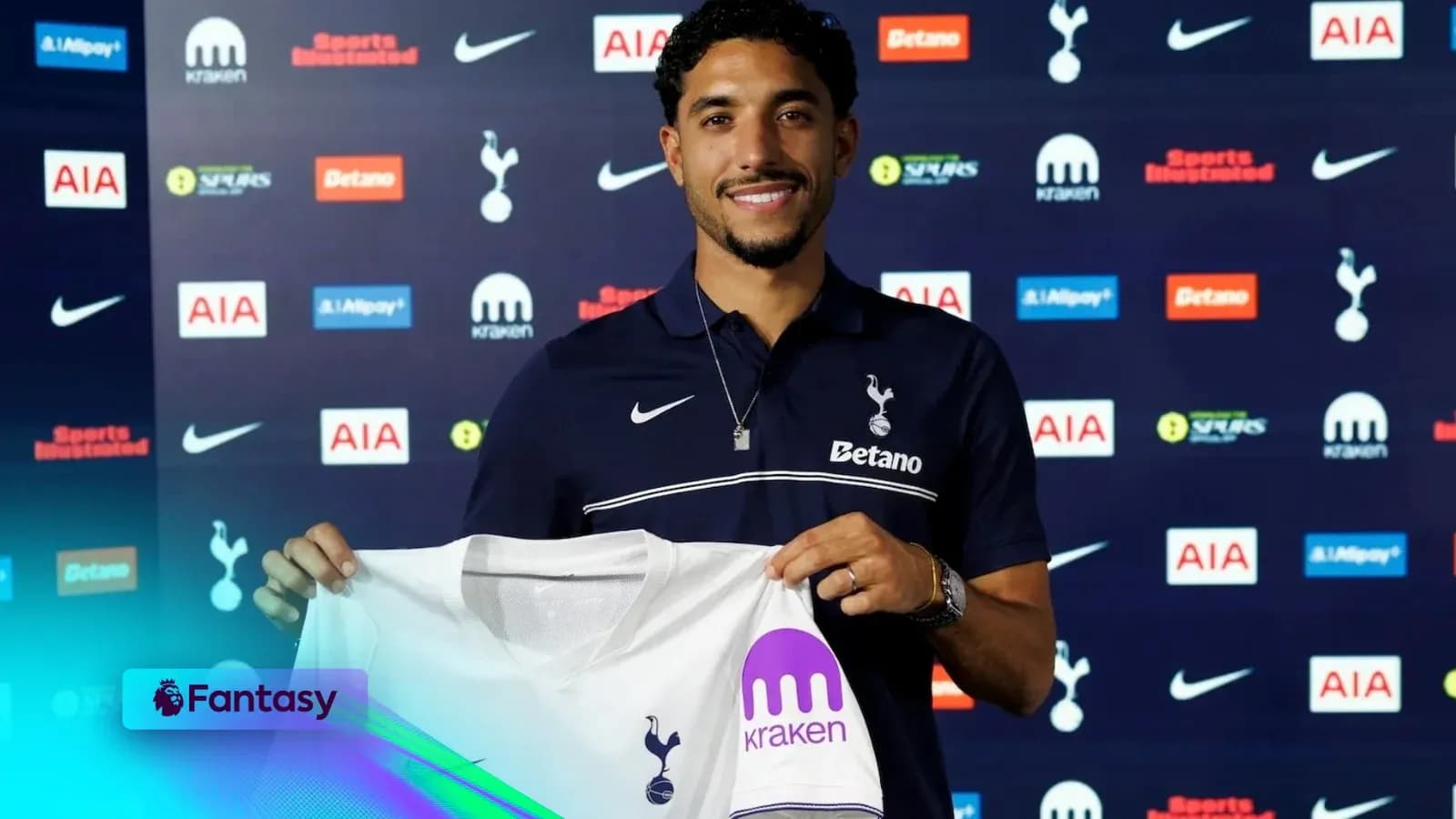 Player holding Tottenham Hotspur jersey at signing event