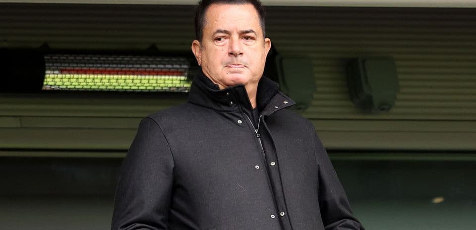 Man in black coat standing in stadium area
