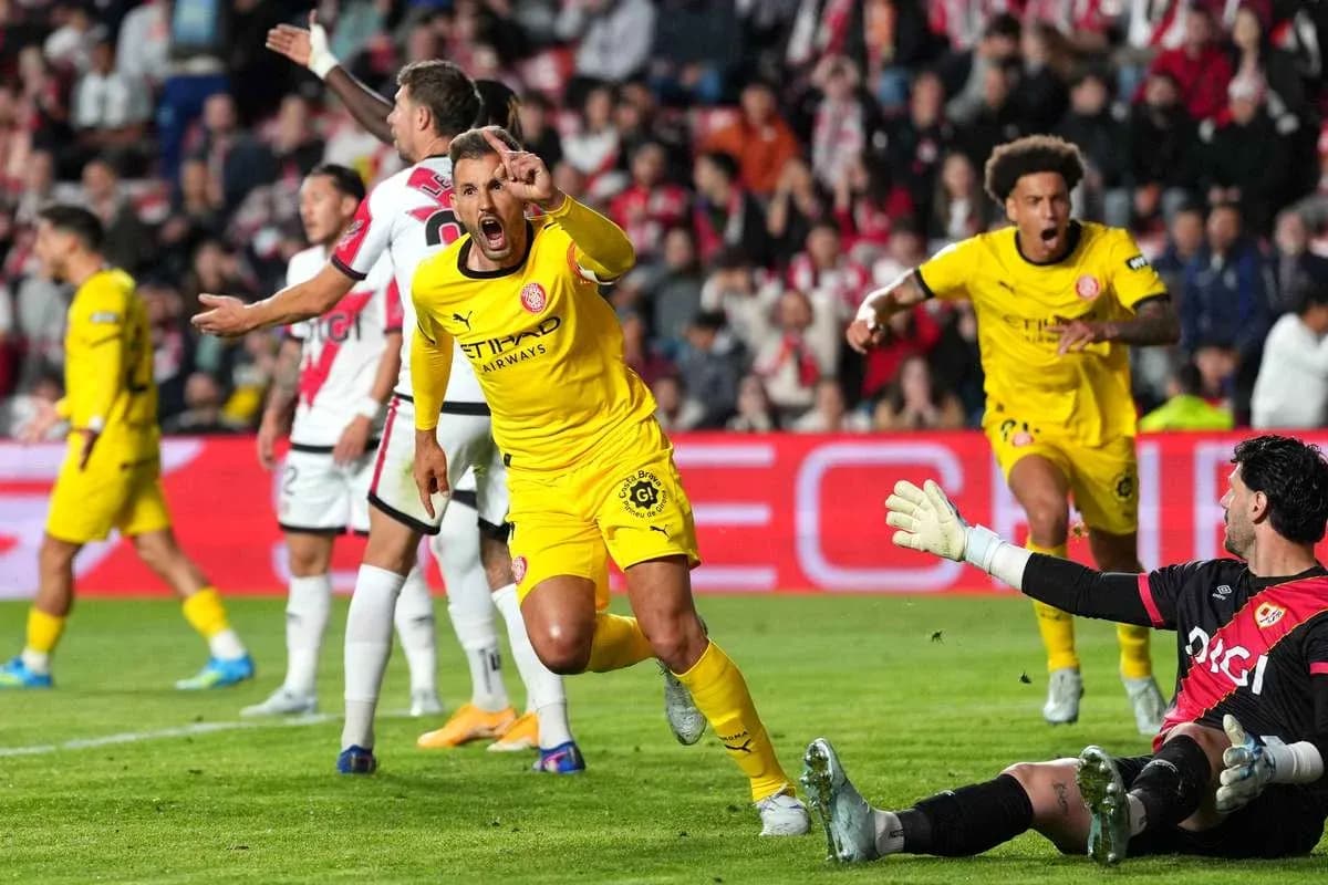 Player celebrating after scoring a goal against goalkeeper